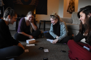 From left, Margaret O'brien, Kate Goodman, Paige Yacobian and Isabel Yuri are playing a round of Cards Against Humanity on Sunday, February 7, 2016 while they impatiently wait for the Super Bowl to begin.